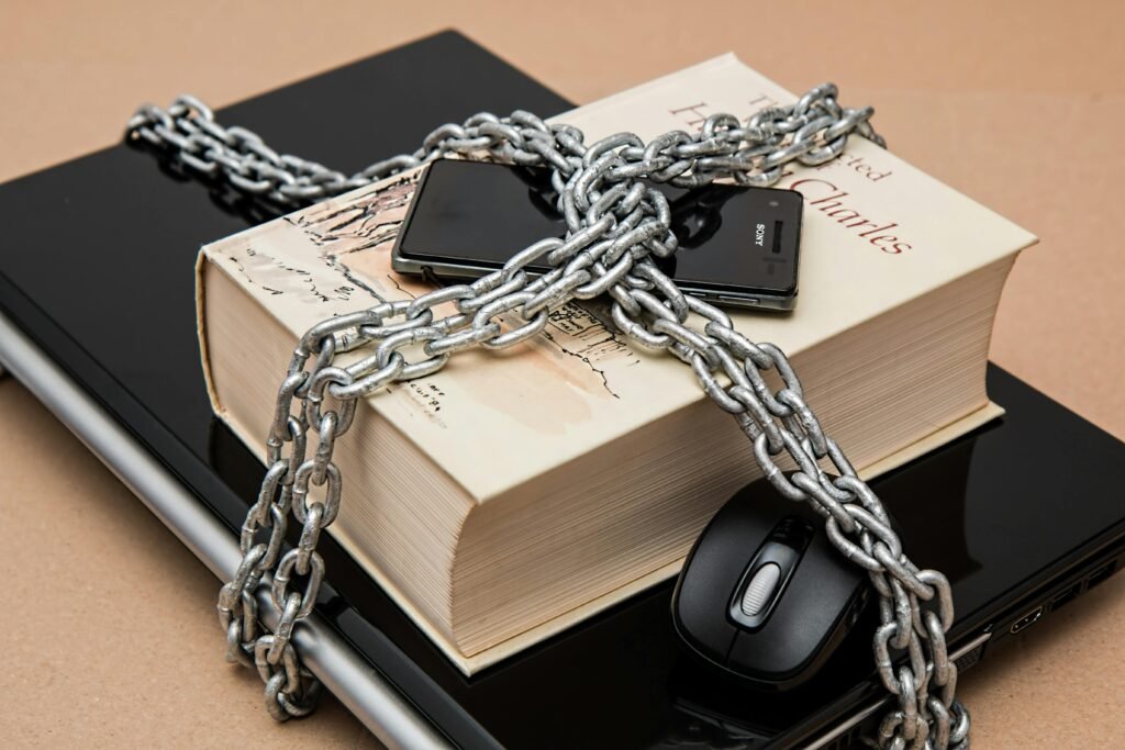 censorship limitations freedom of expression restricted 39584 39584 Chain-locked book, phone, and laptop symbolizing digital and intellectual security.