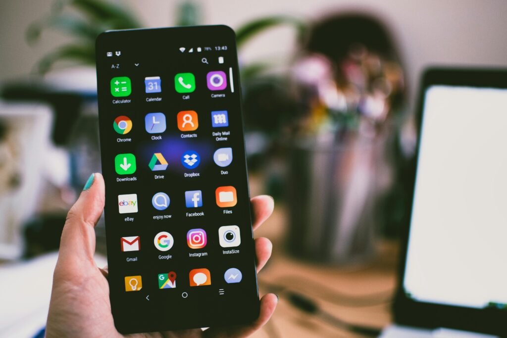 pexels photo 1092644 1092644 A close-up image of a person's hand holding a smartphone displaying best apps college students.