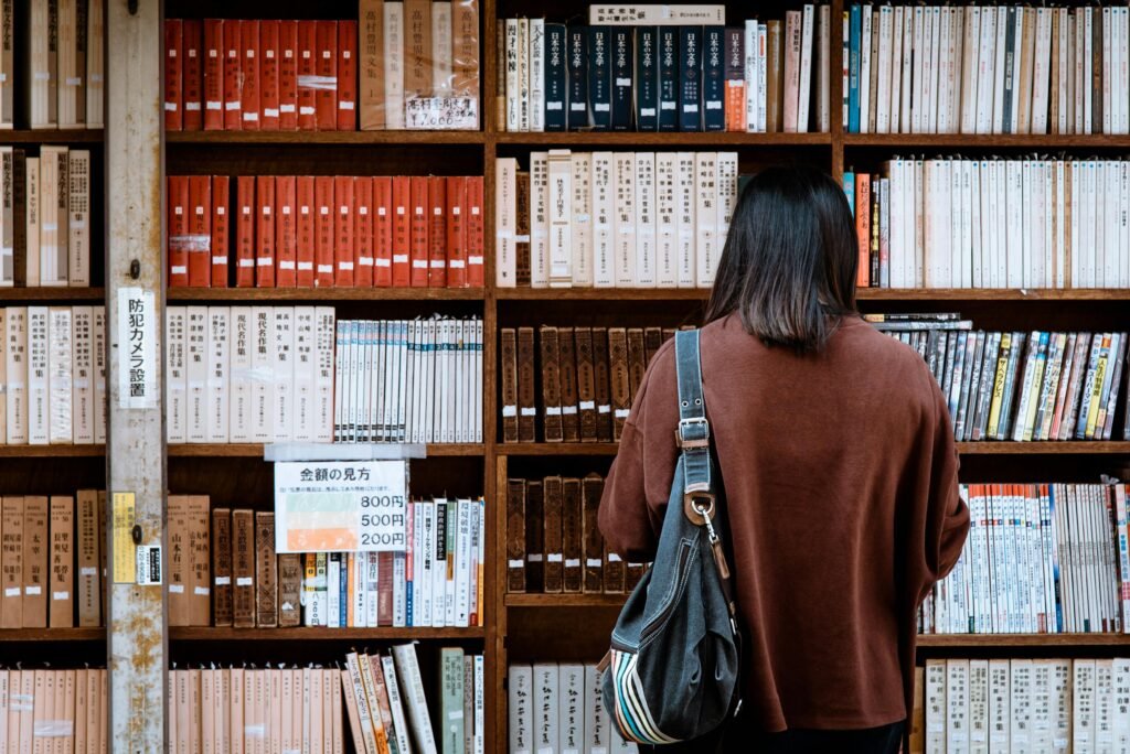 pexels photo 1106468 1106468 Woman browsing books at a library in Nagano, Japan. Explore knowledge and literature.