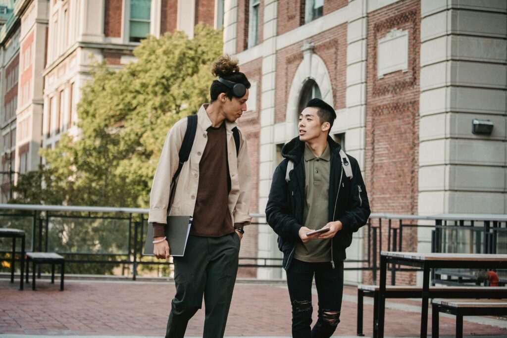 pexels photo 5554276 5554276 Young multiethnic men in casual informal outfit and stylish haircuts promenading and discussing new project while looking at each other