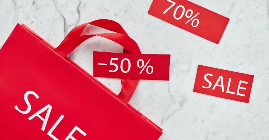 pexels photo 5872186 5872186 Red shopping bag and discount cards with percentages for promotional sale.