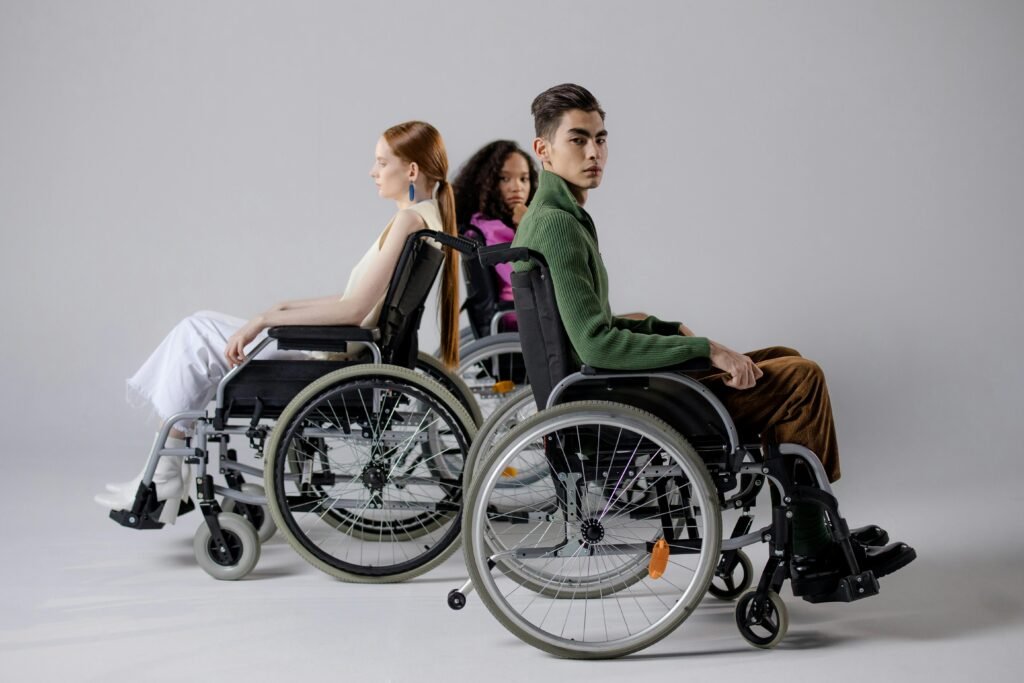 pexels-photo-8543054-8543054 Three diverse individuals in wheelchairs posing indoors, symbolizing inclusivity. disabled student rights