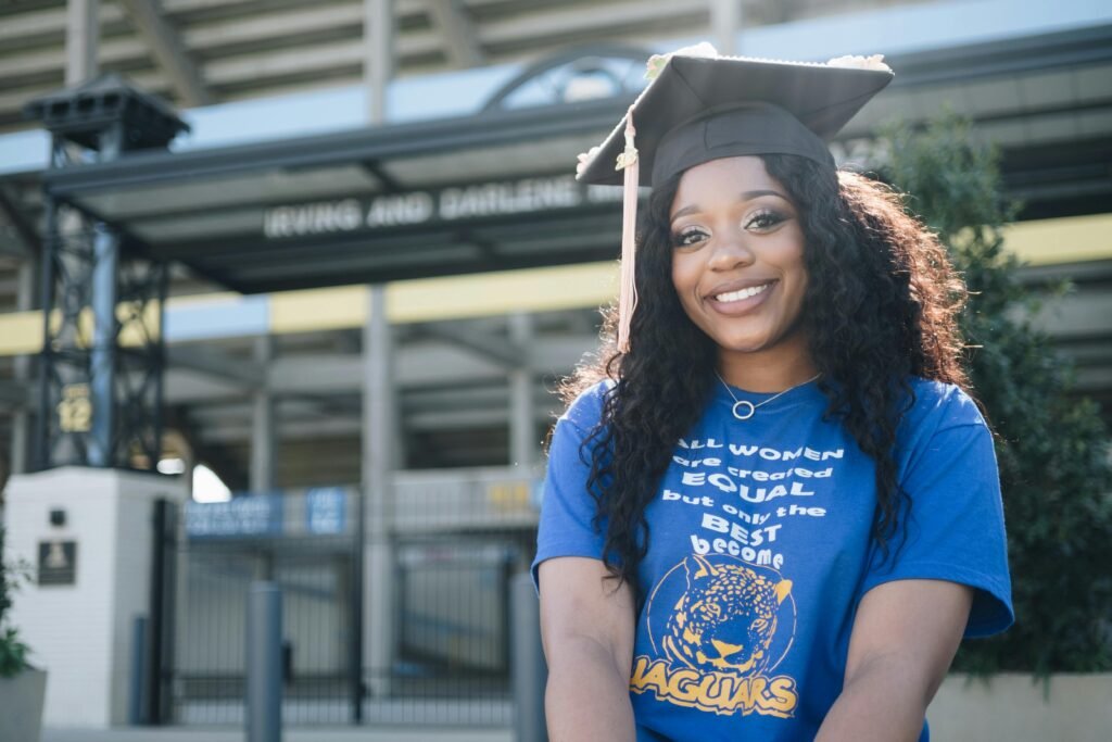 pexels-photo-1139312-1139312 Young woman in graduation cap smiles brightly at Baton Rouge campus.