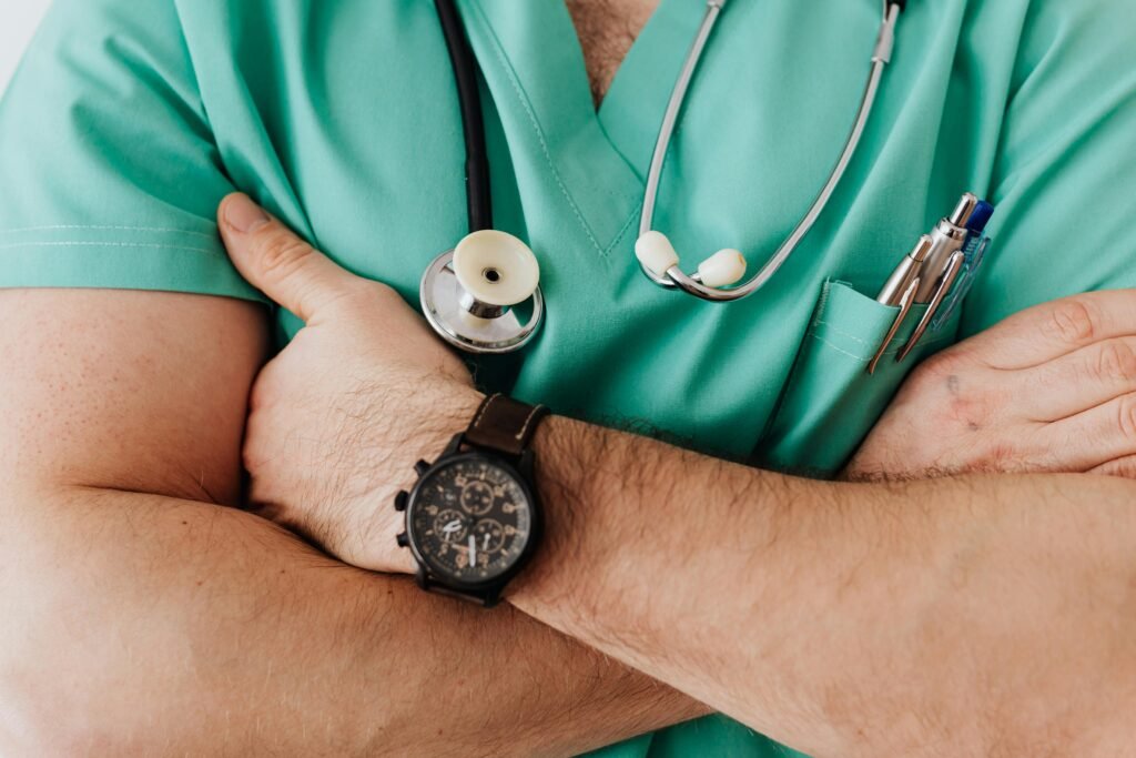 Close-up of a healthcare professional with arms crossed wearing medical scrubs and stethoscope., Study Medicine